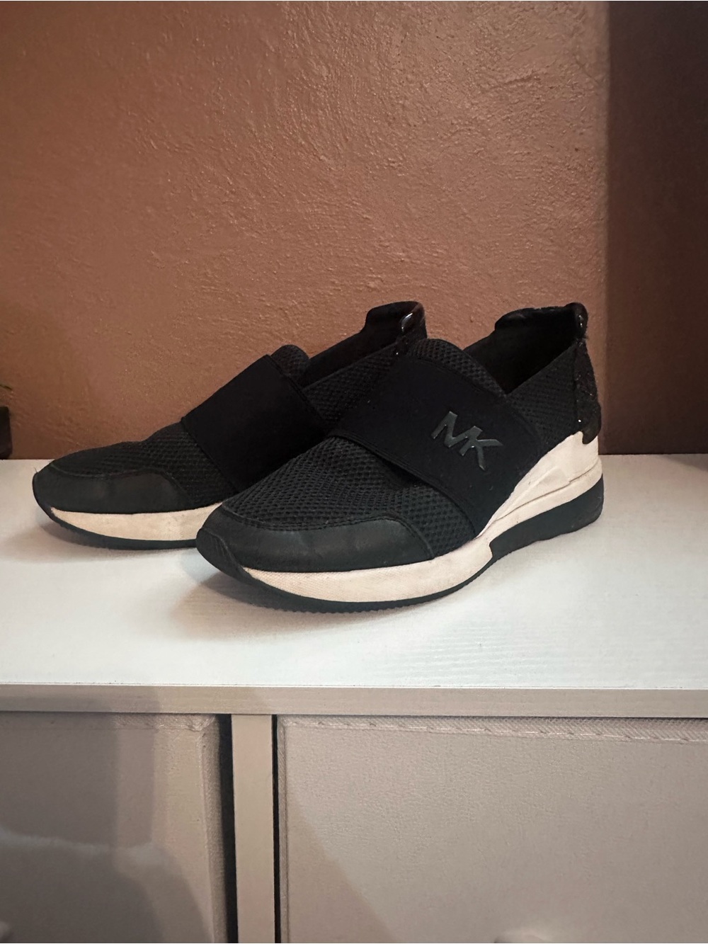 Michael Kors WomensBlack and White Slip-On MK Athletic Sneakers